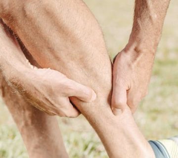 A man holding his leg in pain