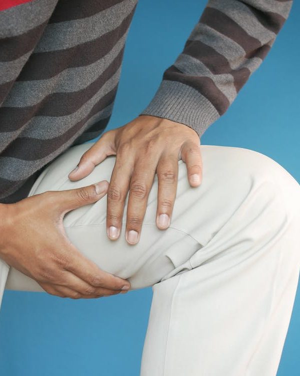 A man holding his thigh in pain