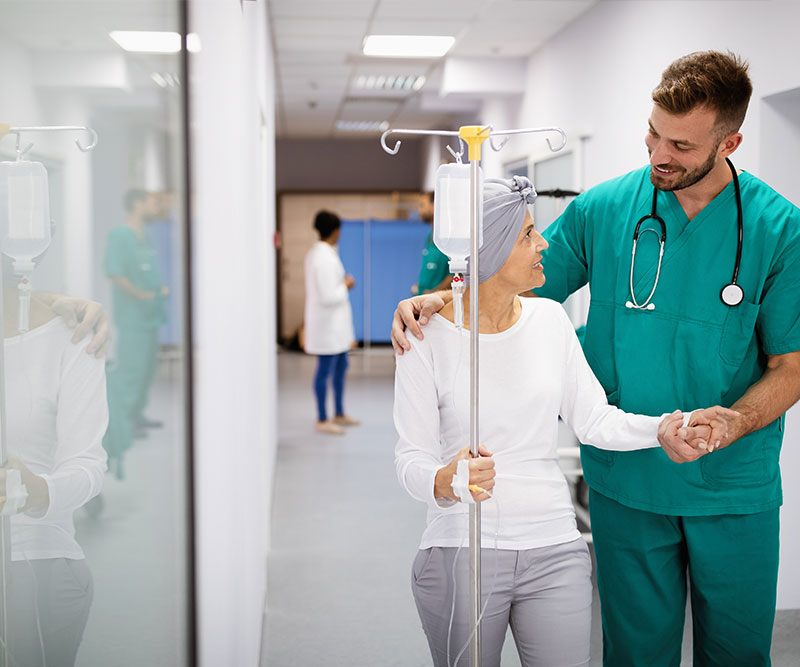 An oncologist talking to an older woman